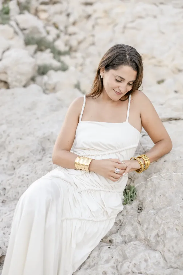 Bride-to-be portrait in a flowing dress on the rocks of Sausset-les-Pins