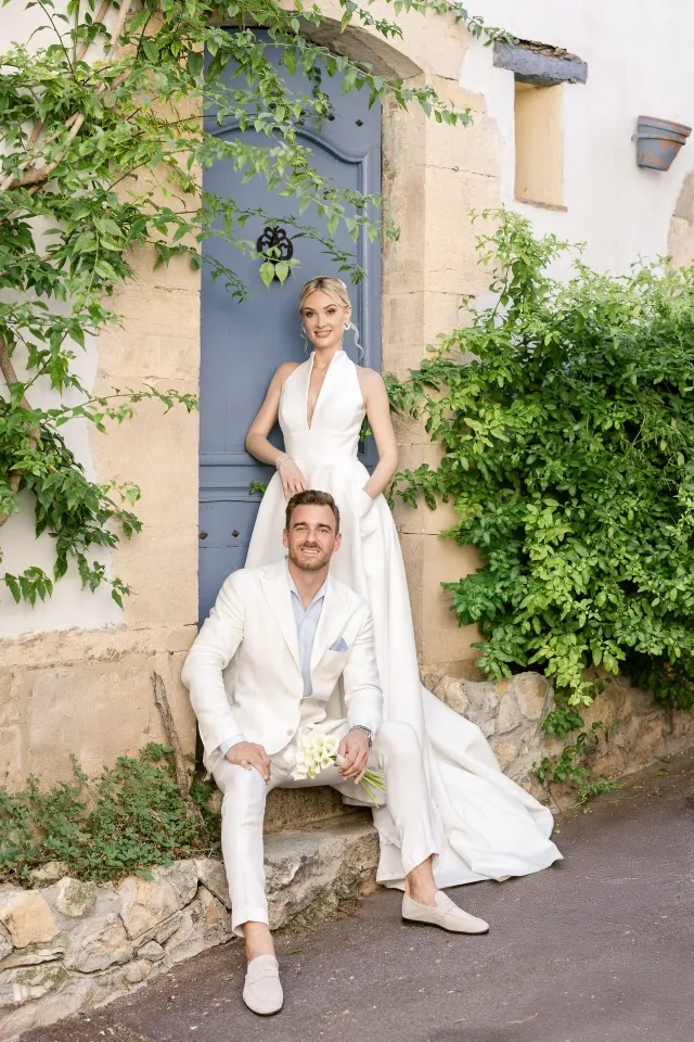 Portrait of the couple in a flower-filled village lane