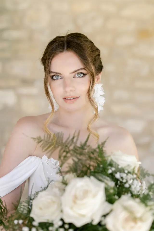 Portrait de la mariée tenant son bouquet, épaules dénudées