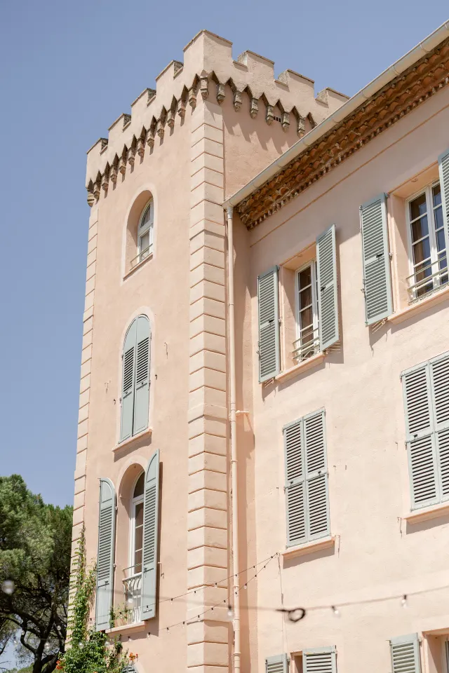 Corner of the château façade under the summer sky