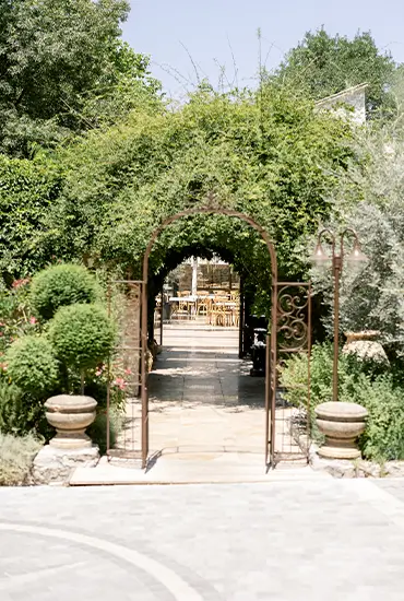 Leafy archway opening onto the estate's gardens