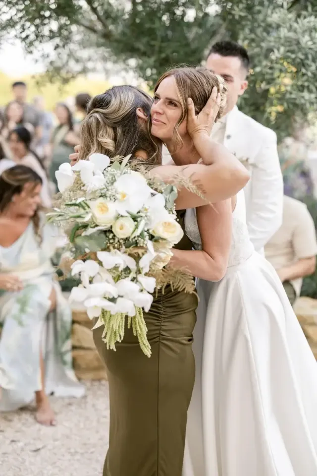 Bride hugging a friend after the ceremony, intimate wedding in Provence